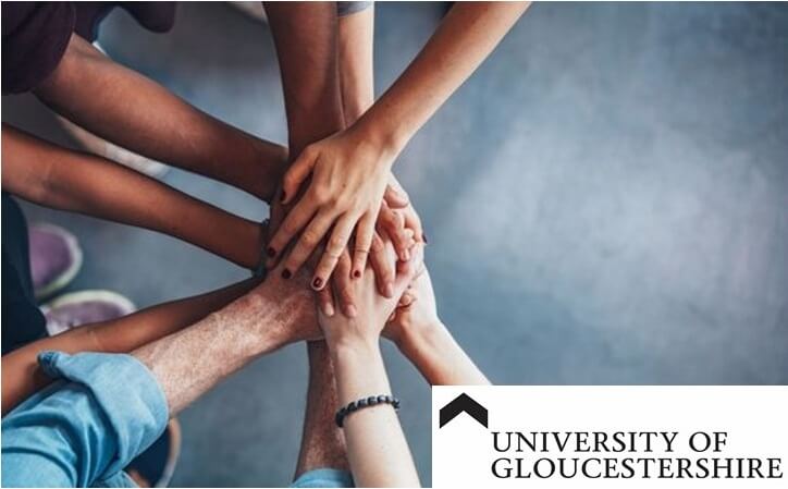 A pile hands to represent diversity with Gloucester University logo