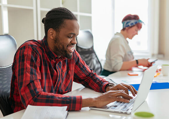 stock image of a man at a laptop