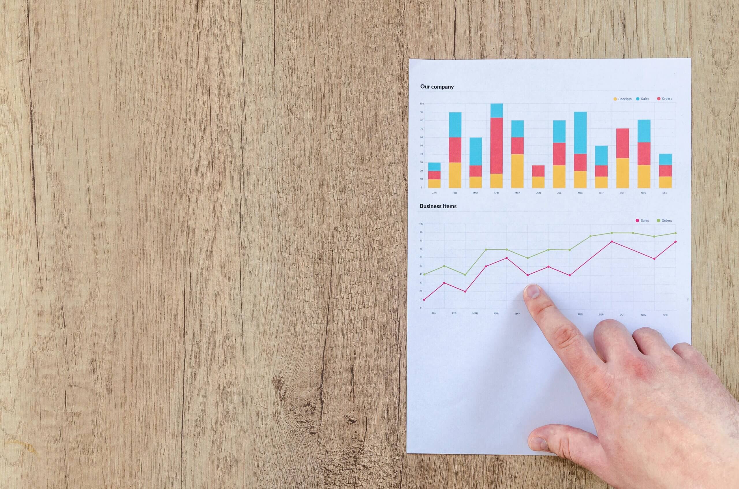 Person Pointing Paper Line Graph.