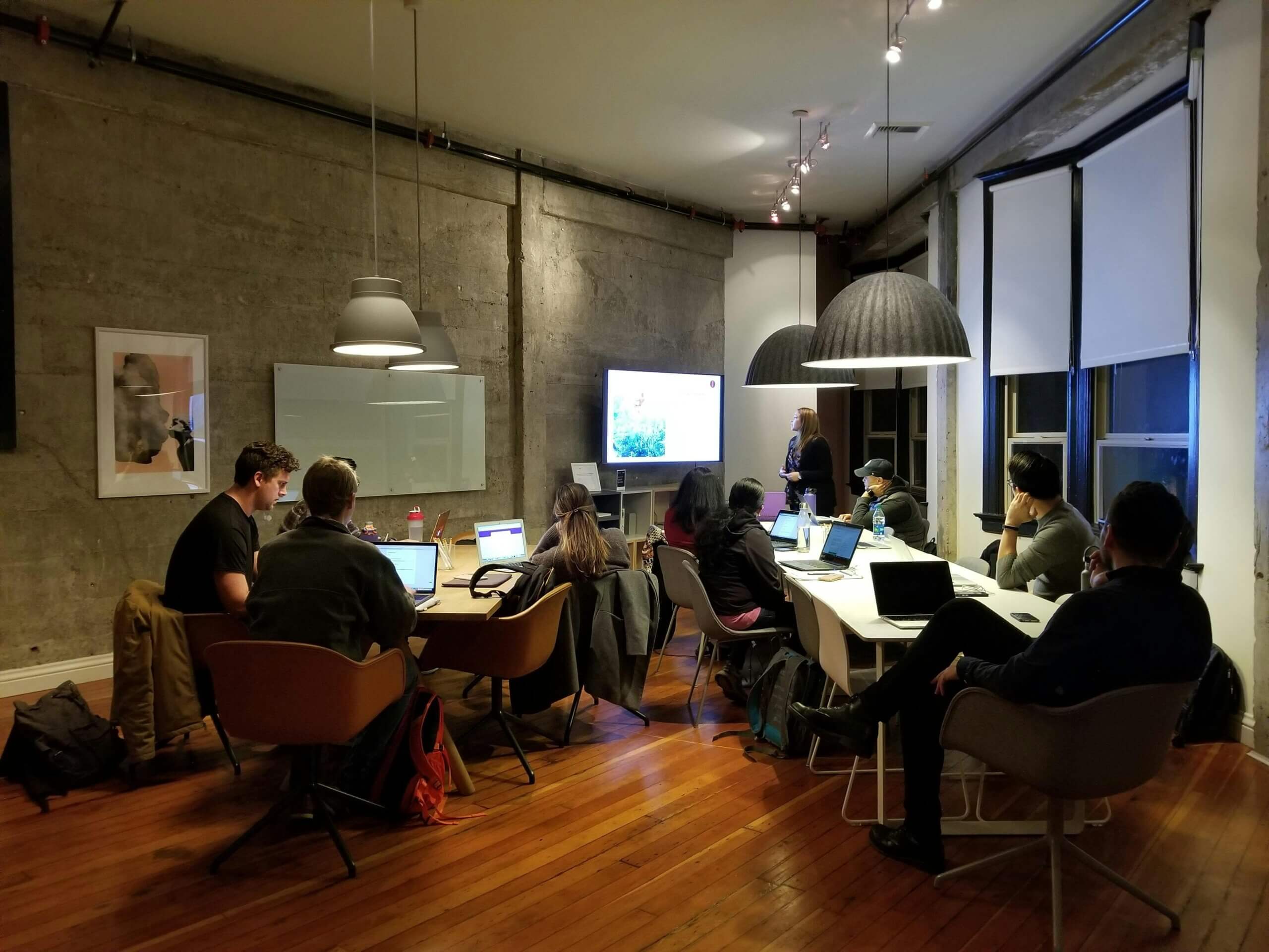 People Gathered Inside One Room Practising Tech Skills.