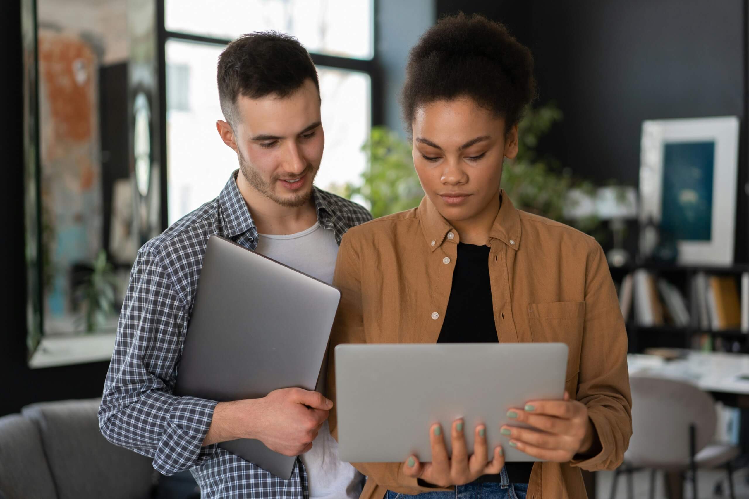 Woman in Brown Blazer Holding White Tablet Computer to Work in Tech.