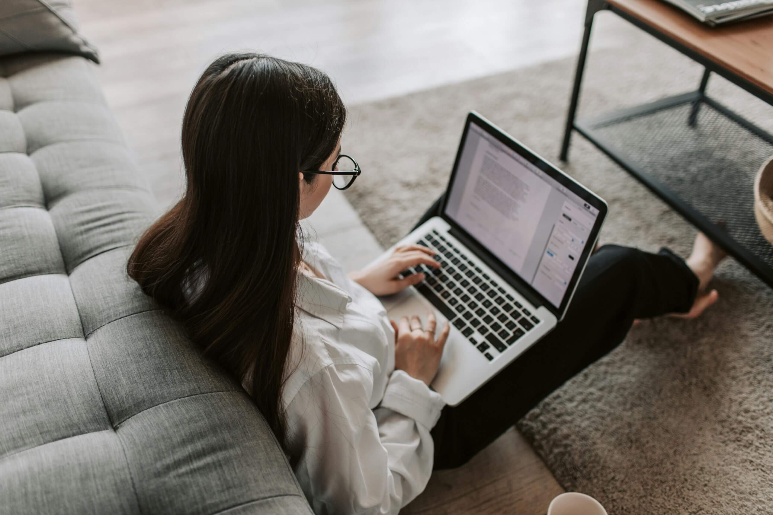 Woman Working At Home Using Her Laptop to Work In Tech.
